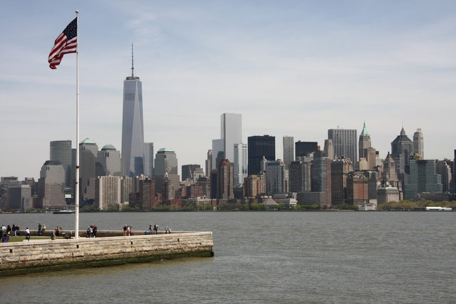 Вид на небоскреб One World Trade Center и флаг США в Нью-Йорке