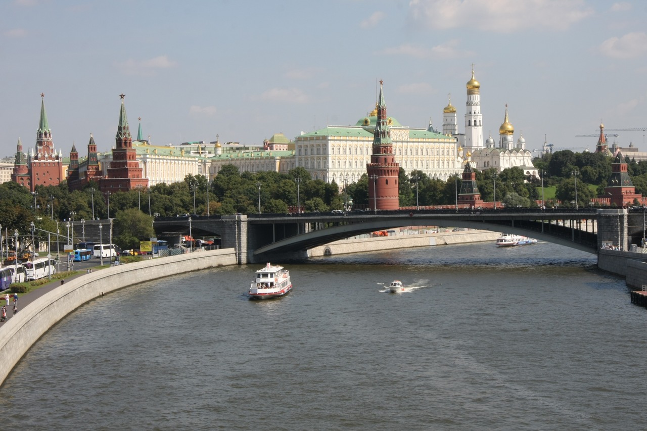 Вид на Московский Кремль и Большой Каменный мост через реку Москву с прогулочными катерами.